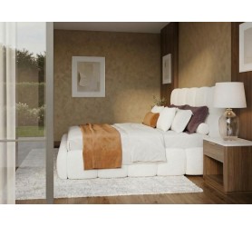 Kadr bokiem na białe łóżko w tkaninie baranek